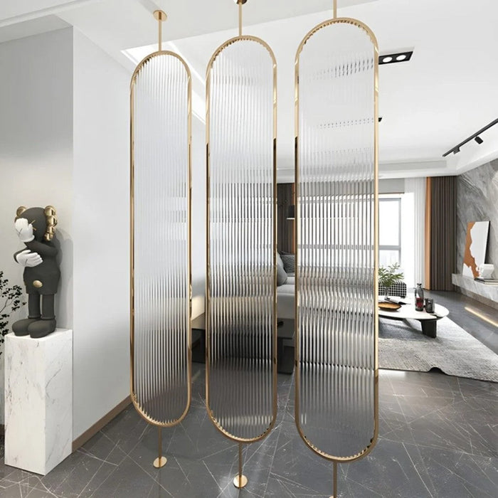 SS PVD gold-frame partition with frosted ribbed glass panels in a modern living room