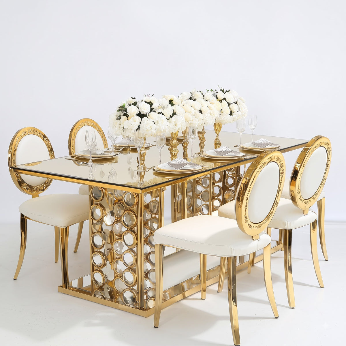 Luxury Gold and White Dining Table Set with Elegant Oval Back Chairs, Mirrored Glass Tabletop, Ornate Metallic Base, and Beautiful White Rose Centerpiece for Modern Royal Dining Room Interior Decor