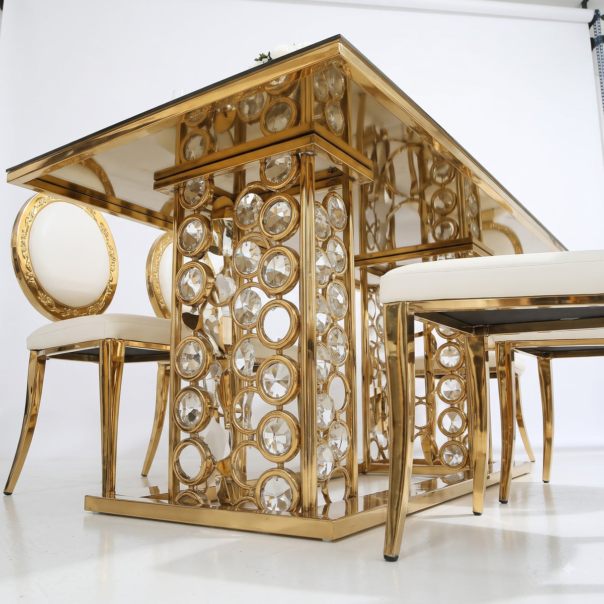 Luxury Gold and White Dining Table Set with Elegant Oval Back Chairs, Mirrored Glass Tabletop, Ornate Metallic Base, and Beautiful White Rose Centerpiece for Modern Royal Dining Room Interior Decor