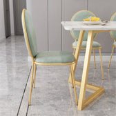 Luxury White Marble Dining Table with Gold Geometric Legs and Sage Green Chairs